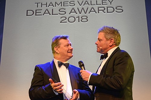 Picture of a man presenting an award to another man